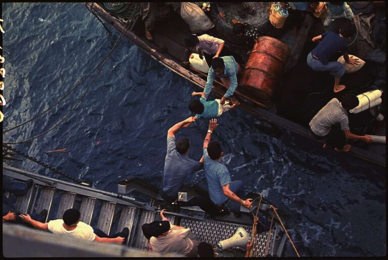 South_China_Sea….Crewmen_of_the_amphibious_cargo_ship_USS_Durham_(LKA-114)_take_Vietnamese_refugees_aboard_a_small…_-_NARA_-_558518.tif